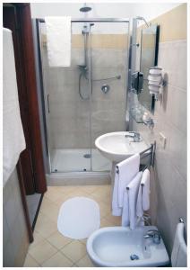 a bathroom with a shower and a sink and a toilet at 1A Grace House in Rome