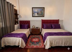 two beds sitting next to each other in a room at Homestay Shah Alam OneB, 2-12 pax, I-city & UiTM in Shah Alam