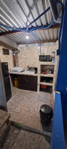 a kitchen with a stove and a counter in a room at Hostal Niña Oly in El Sunzal