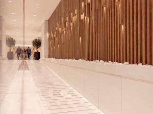 a hallway with people walking in a building at Fairmont Dubai in Dubai