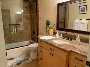 a bathroom with a sink and a toilet and a mirror at Spacious 3 bedrooms 1 bath Jacuzzi BBQ SINGLE HOUSE in Agoura Hills +16 photos
