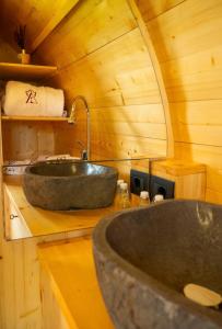 a bathroom with a large stone sink in a cabin at Ámpelos Wine Room in Gallo