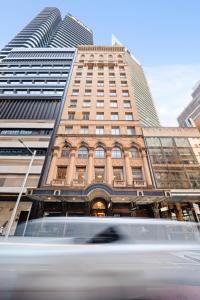 a tall building with a van in front of it at Castlereagh Boutique Hotel, an Ascend Collection Hotel in Sydney