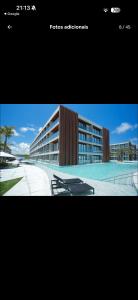 a picture of a building with chairs in front of it at Gave risort Porto life 2 in Porto De Galinhas