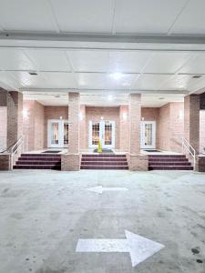 an empty building with a white arrow on the ground at COLLINS INN & SUITES in Collins