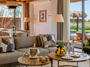 a living room with a couch and tables with fruit on it at Fairmont Royal Palm Marrakech in Marrakesh