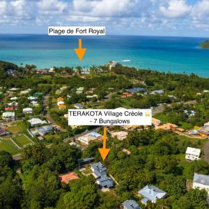 an aerial view of a town with the ocean at Terakota lodge in Deshaies