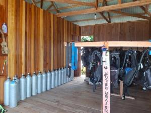 a row of fire hydrants lined up in a barn at Gloria Dive Homestay in Keruo