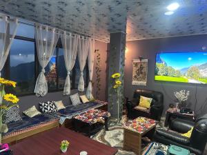 a living room with a couch and a tv at Karma homestay in Ravangla