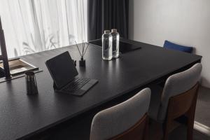 a black table with a laptop computer on it at UNIT Nuanu Village in Canggu +79 photos