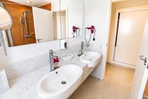a white bathroom with a sink and a mirror at Private Iberosta Villa Lagoon 4BDR- Private Beach and Pool in Punta Cana +51 photos