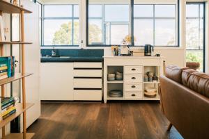 a kitchen with a sink and a counter with windows at VeraLuna in Garden Island Creek +47 photos