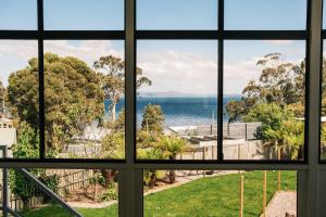 a window view of the ocean from a house at VeraLuna in Garden Island Creek