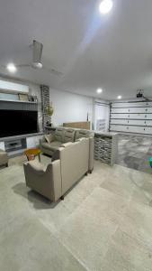 a living room with a couch and a flat screen tv at Casa lujosa lorica in Lorica