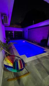 a swimming pool at night with a purple lighting at Casa lujosa lorica in Lorica