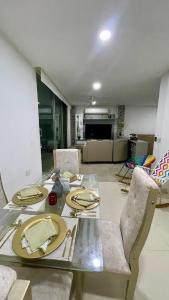 a dining table and chairs in a living room at Casa lujosa lorica in Lorica +3 photos