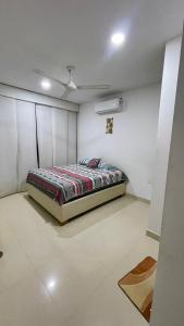 a bedroom with a bed and a ceiling fan at Casa lujosa lorica in Lorica