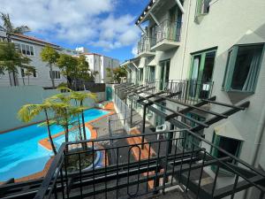 a balcony of a building with a swimming pool at Parklane Motor Lodge in Auckland