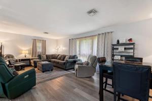 a living room with a couch and a table at Arden Place - Spacious Retreat with Pool in High Point