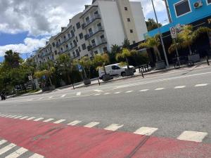an empty street with a white truck parked in front of a building at ABRA residence alverca in Quinta da Verdelha