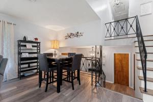 a dining room with a table and chairs and a staircase at Arden Place - Spacious Retreat with Pool in High Point +26 photos
