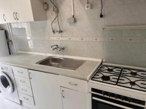 a kitchen with a sink and a stove at ABRA residence alverca in Quinta da Verdelha