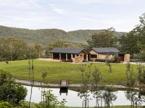 a house with a pond in front of it at Villa Arbosana in Barrengarry