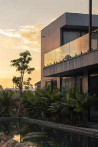 a building with a lot of plants in front of it at UNIT Nuanu Village in Canggu
