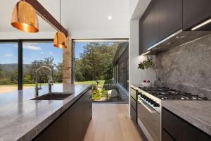 a kitchen with a sink and a stove top oven at Villa Arbosana in Barrengarry