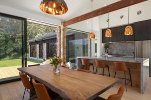 an open kitchen and dining room with a wooden table and chairs at Villa Arbosana in Barrengarry