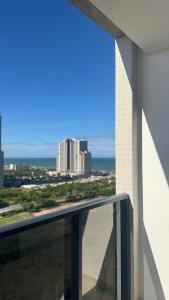 a view of the city from the balcony of a building at Vila confort in Vila Velha