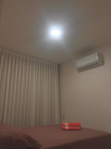 a room with a bed and a air conditioner on the ceiling at Vila confort in Vila Velha