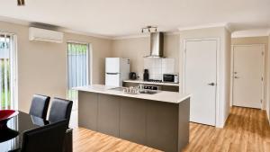 a kitchen with a kitchen island with a counter top at Napolean Holiday Retreat in Vasse