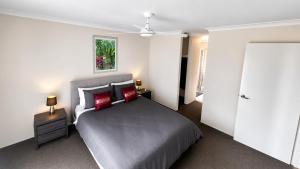 a bedroom with a bed and a ceiling fan at Napolean Holiday Retreat in Vasse