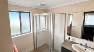 a bathroom with a shower and a sink at Napolean Holiday Retreat in Vasse +22 photos