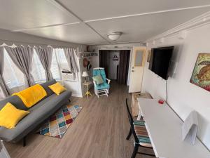 a living room with a couch and a table at The Salty Camper in North Topsail Beach