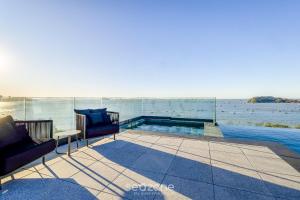 a swimming pool with a view of the water at Studios in a seaside building, close to Beto Carreiro at Penha Spot - PSOB in Gravata