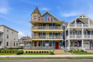 a large yellow and blue house with a turret at The Marilyn Inn in Ocean Grove