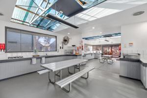 a large kitchen with benches and tables in it at BIG4 Ingenia Holidays Phillip Island in Newhaven