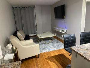 a living room with a white couch and a tv at Bold property in Calgary
