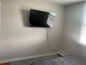 a bedroom with a flat screen tv on the wall at Bold property in Calgary
