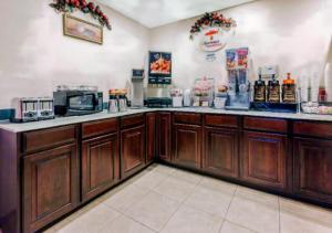 a kitchen with wooden cabinets and a counter top at Highland Inn in Arlington