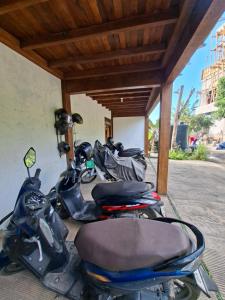 a group of scooters parked under a building at Uluwatu Sunrise in Uluwatu