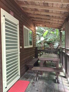 a wooden porch with a picnic table and a door at Beauty House in Nanzhuang