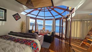 a living room with a large room with a large window at Titicaca island lodge peru in Puno +40 photos