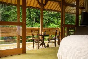a bedroom with a bed and a table and chairs at The Villa Lululu in Tabanan