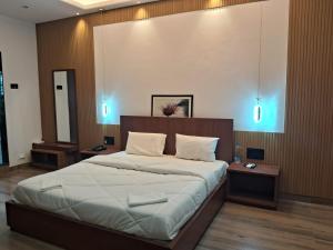 a bedroom with a large bed with blue lights at Hotel Brindavan Grand in Gulbarga