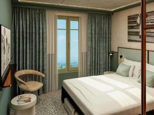 a hotel room with a bed and a chair at TRIBE Hôtel Le Touquet in Le Touquet-Paris-Plage +73 photos