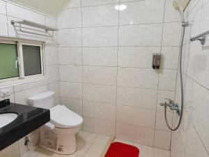 a bathroom with a shower and a toilet and a sink at Beauty House in Nanzhuang +29 photos