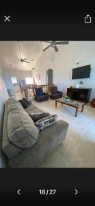 a living room with a couch and a tv at Cozy House, Ocean View, Saint Thomas in Contant